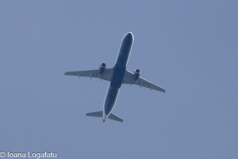 Airplane gliding through a cloudy sky above